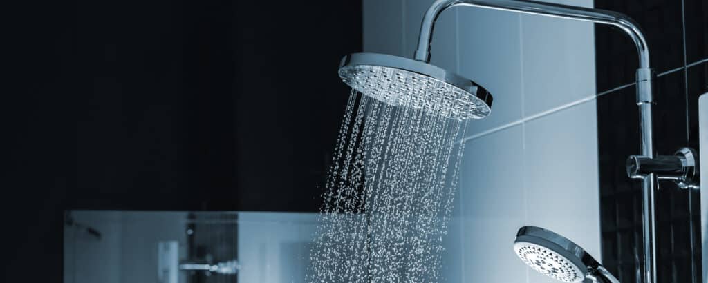 Close up of Water flowing from shower in the bathroom interior